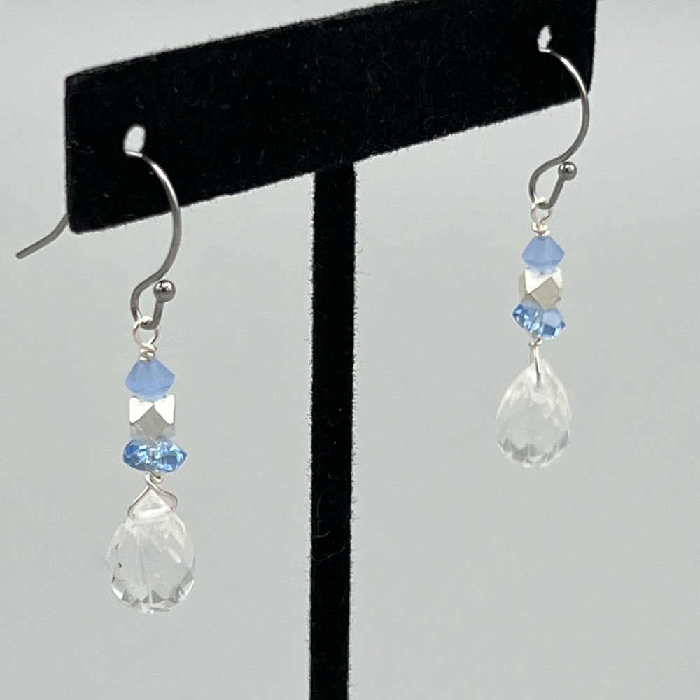 Clear faceted quartz drops with sapphire blue accents on silver wire.